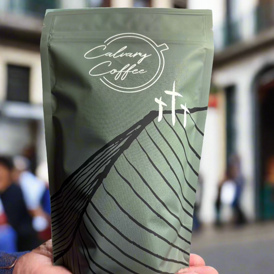 Calvary Coffee bag being held on a hand