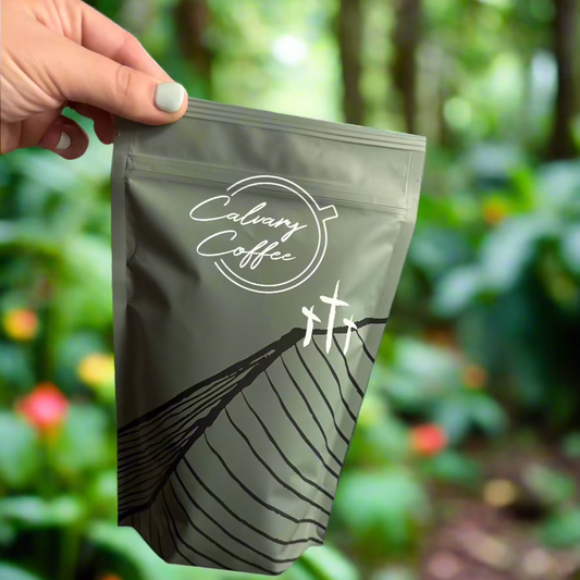 Calvary Coffee bag depicted in rainforest